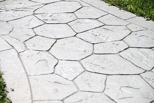 light grey natural stone stamped concrete pathway