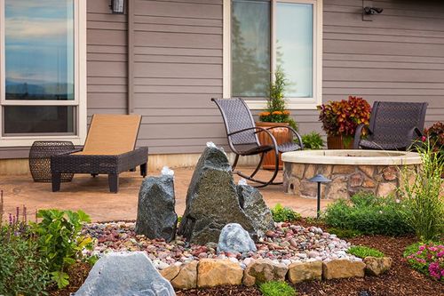 3 bubbling rocks in a rock garden