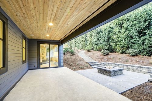 modern concrete patio underneath deck