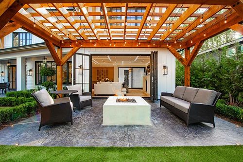 wooden pergola directly outside of a home's patio doors