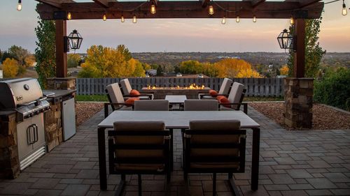 modern pergola with string lights and outdoor furniture