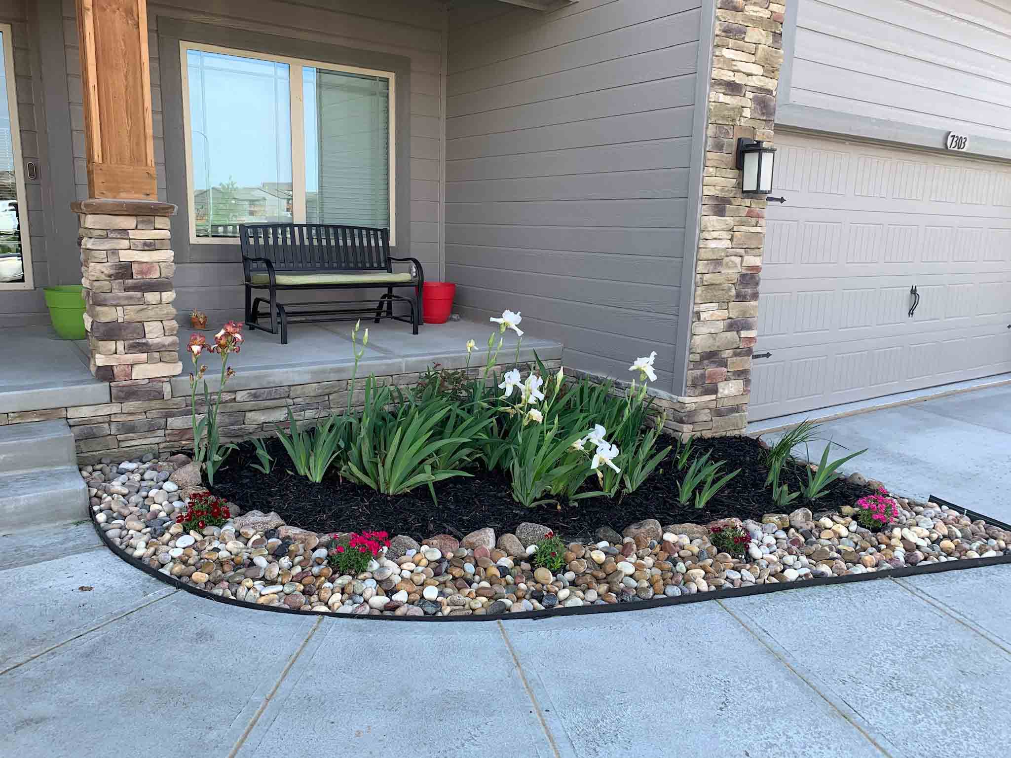 front yard rock and mulch garden with flowers